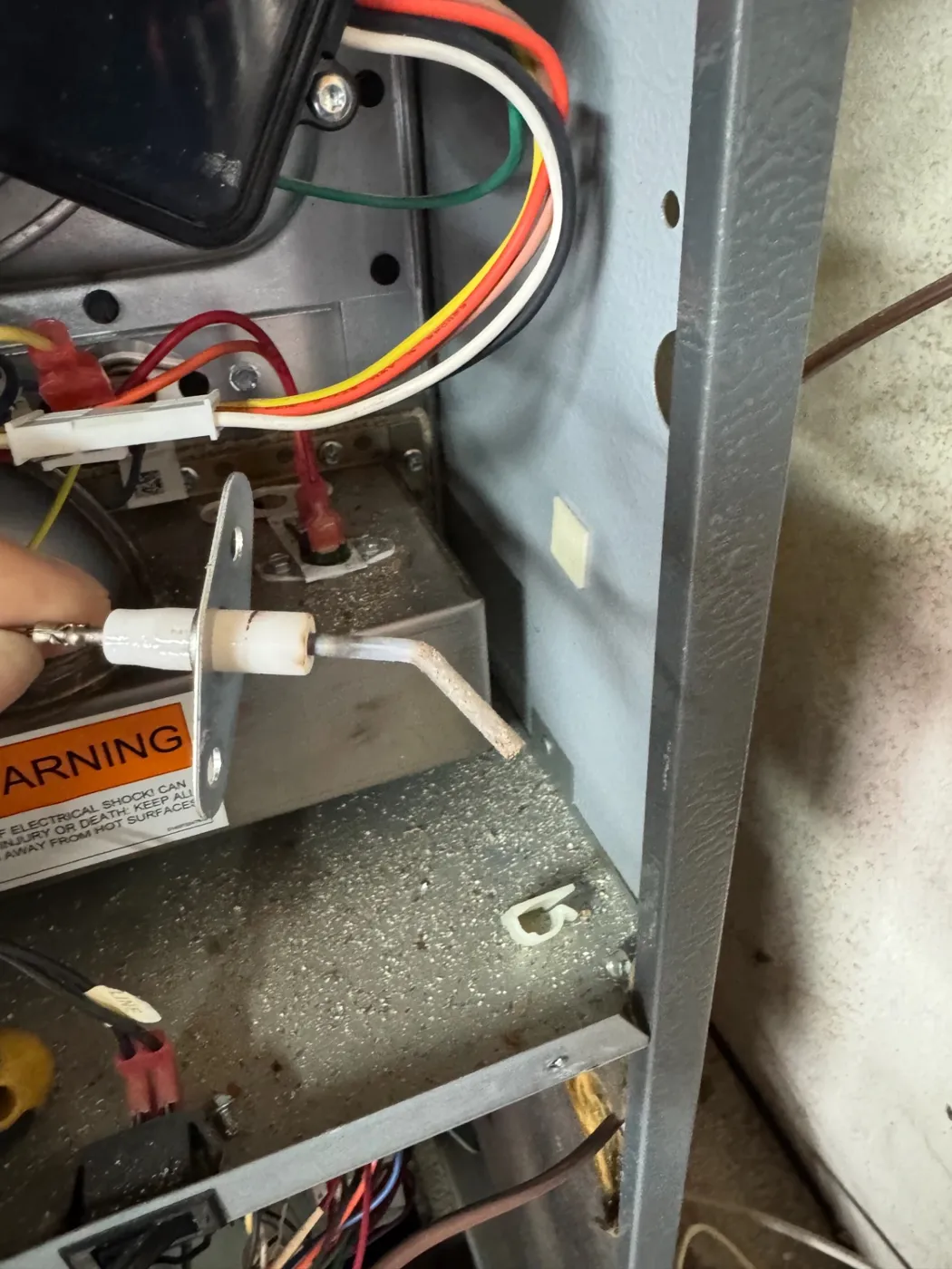 CrossBreeze tech replacing a furnace hot surface igniter during a repair call