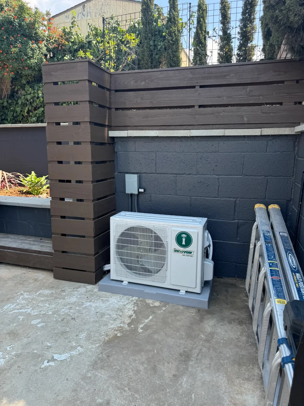 Innovair mini split condenser installed on a pad beside a San Diego patio